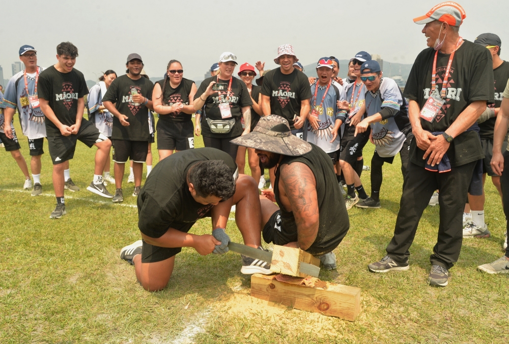 應邀來訪的紐西蘭毛利族代表參與傳統鋸木賽，地主台北市隊為他們加油。112原民運籌備會提供。