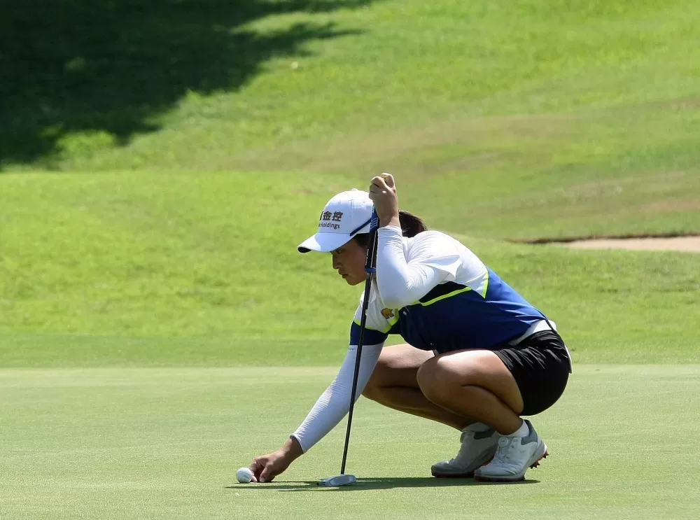 吳佳晏在果嶺判讀推桿路線。