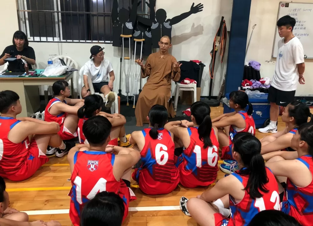 普門女籃練完球後，主管籃球事務的慧功師父予球員心靈開示。